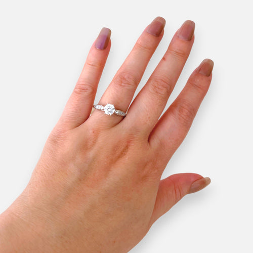 Anillo solitario Hv Hermanas Villegas plateado con circonia central y banda labrada en mano de mujer