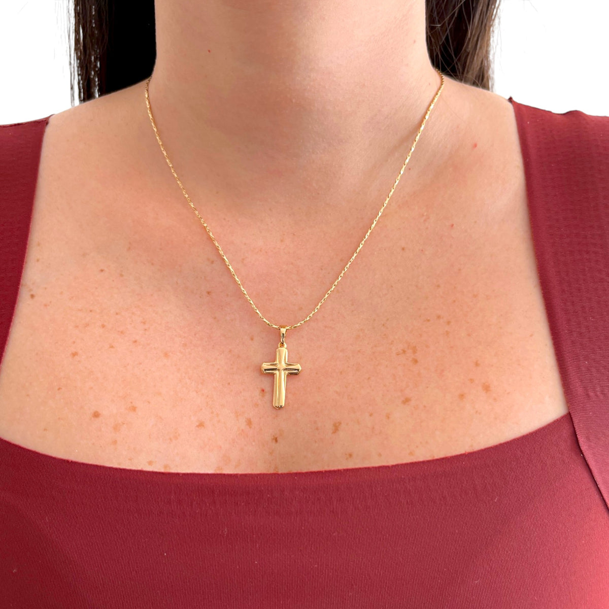 Collar Hv Hermanas Villegas con cadena entorchada y dije de cruz clásica en baño de oro rosé sobre modelo
