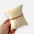 Pulsera Hv Hermanas Villegas de tejido espiga doble en cobre con enchape de oro rosa