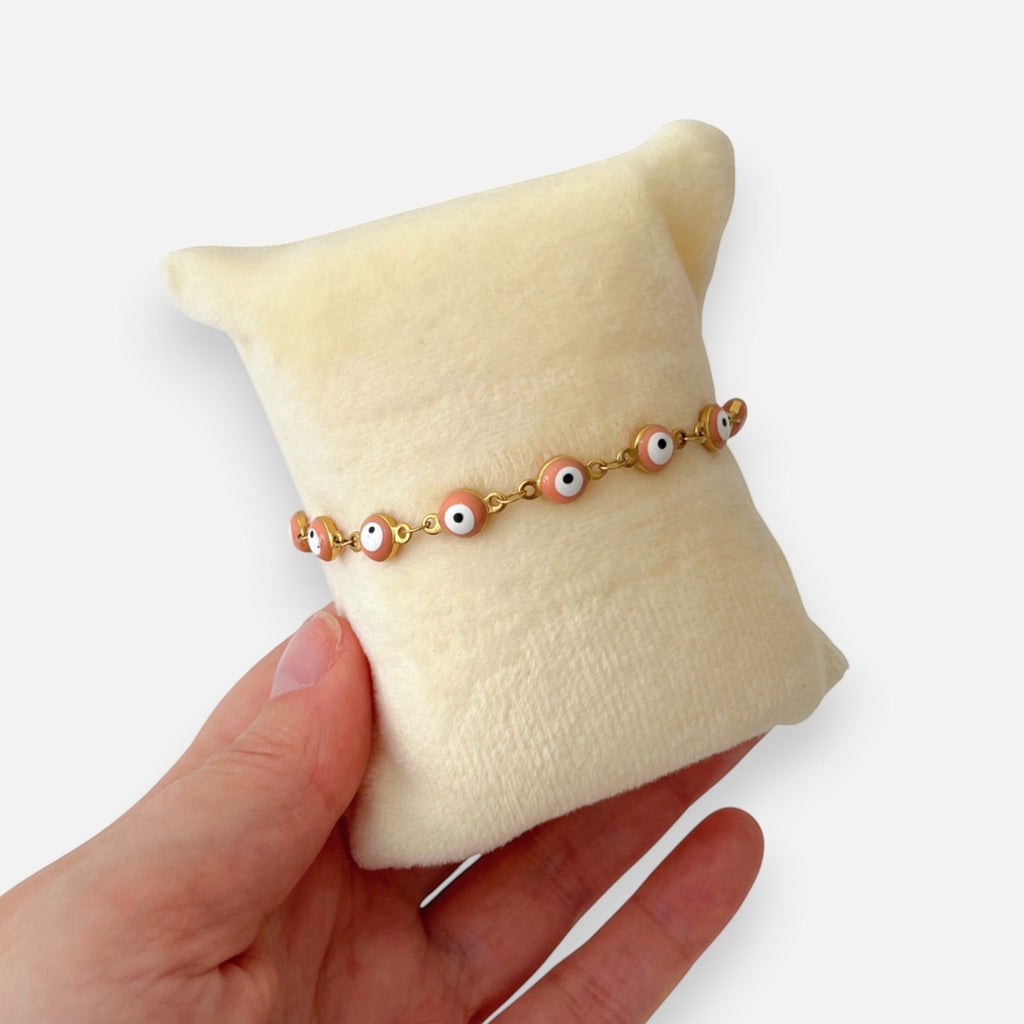 Pulsera Hv Hermanas Villegas de acero dorado con dijes de ojo turco en color rosa pastel