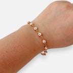 Pulsera Hv Hermanas Villegas de acero dorado con dijes de ojo turco en color rosa pastel