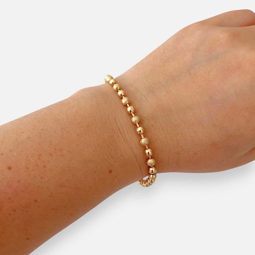 Pulsera Hv Hermanas Villegas de esferas y balines texturizados en oro rosa