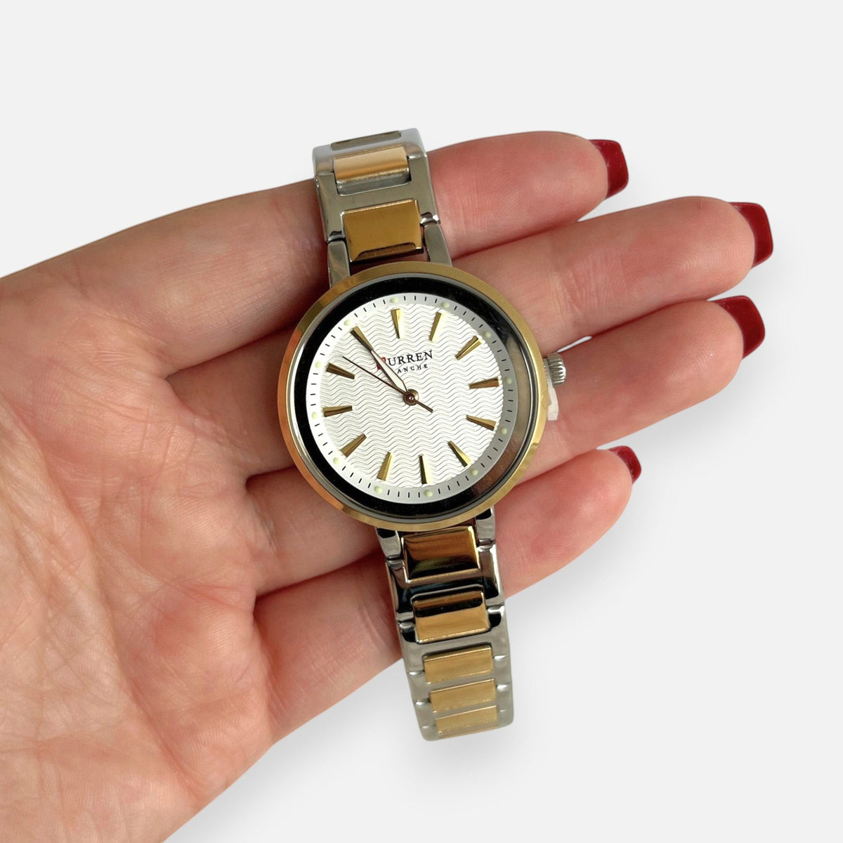 Reloj Hv Hermanas Villegas bicolor en acero con dial blanco texturizado y caja redonda dorada y plateada