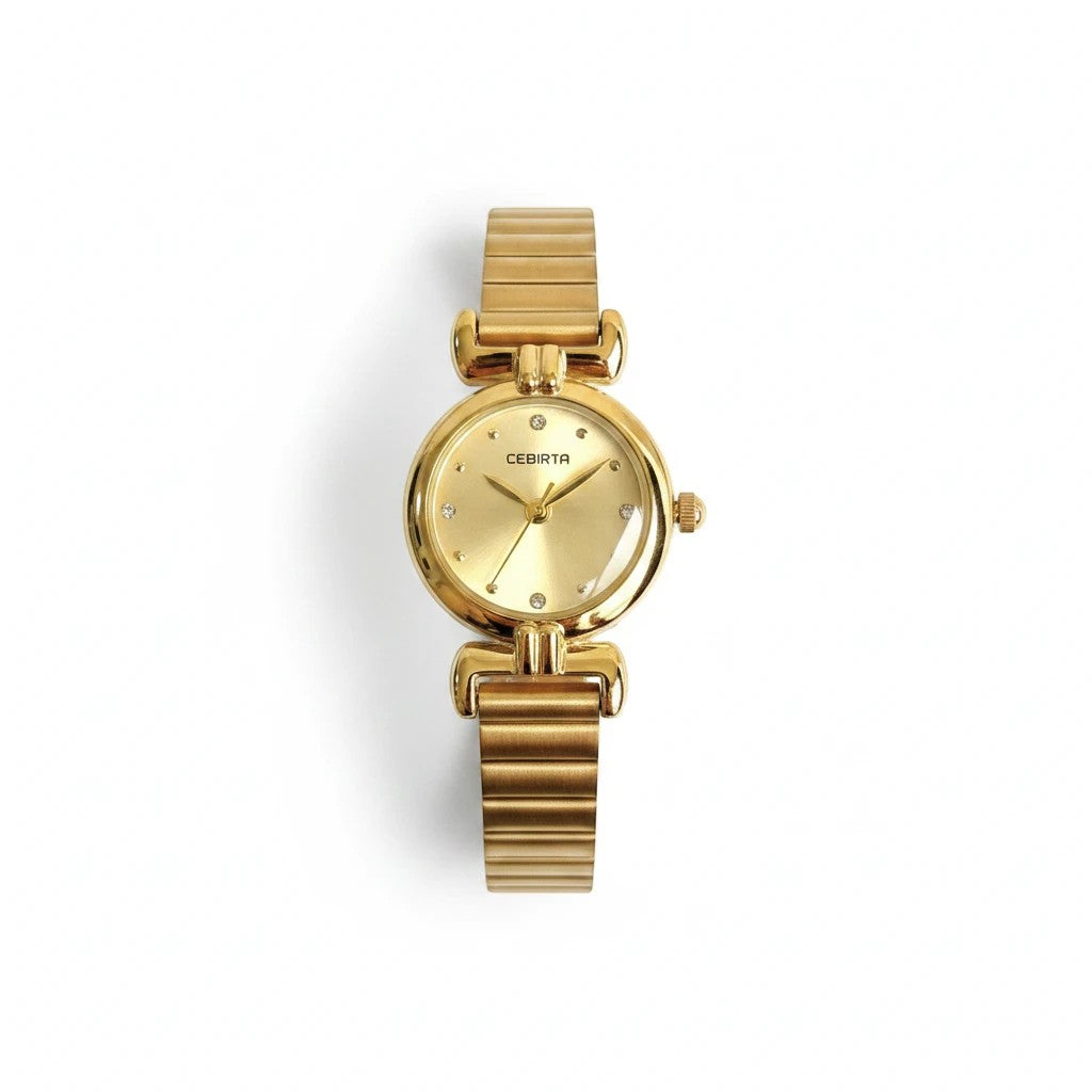 Reloj analógico Hv Hermanas Villegas de acero dorado con caja redonda, dial cepillado y detalles brillantes.