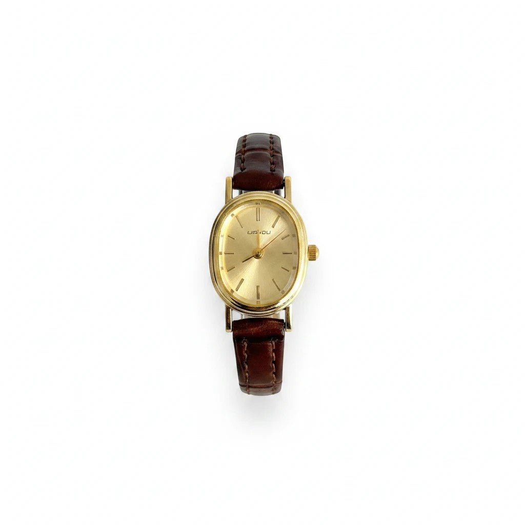Reloj Hv Hermanas Villegas con caja ovalada dorada, dial cepillado y correa de cuero vegano café estilo vintage